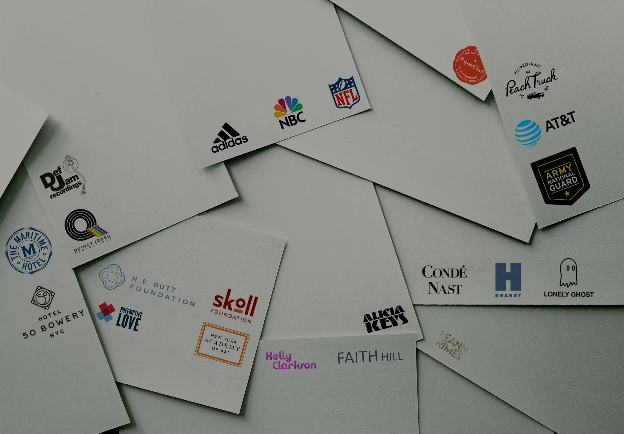 Scattered business cards featuring logos of NFL, NBC, Adidas, Alicia Keys, Def Jam, and other Waterloo Digital clients